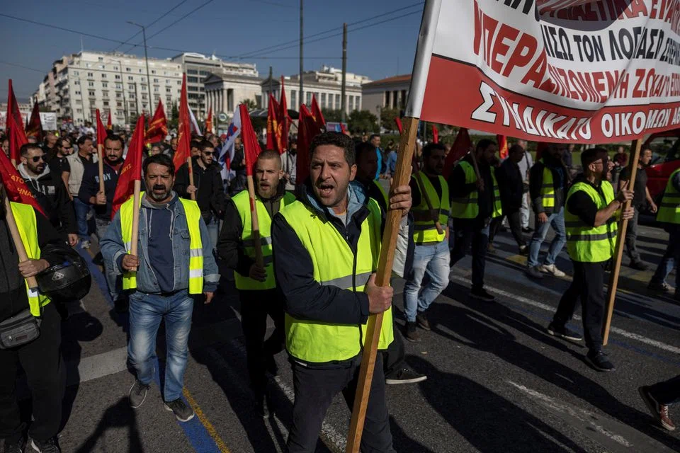 In Athens, thousands of people marched in the second 24-hour walkout this year over rising inflation, some holding up banners that read, “No to layoffs, no to pay cuts.”