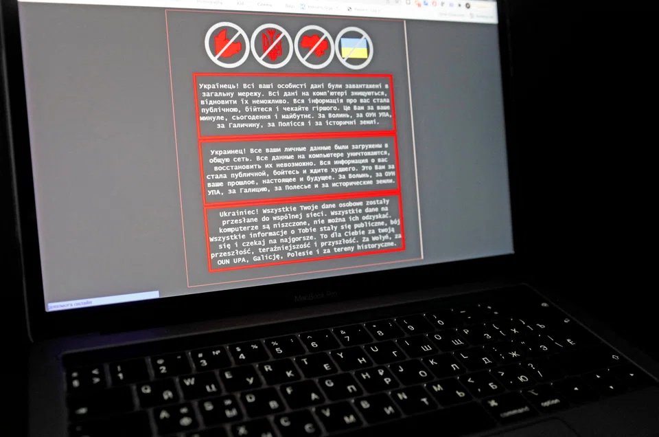 A laptop screen displays a warning message in Ukrainian, Russian and Polish. The message appeared on the official website of the Ukrainian Foreign Ministry after a cyberattack, Jan 14, 2022. 
