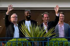 (FromL) Cannes Film Festival director Thierry Fremaux, French director and member of the Jury of the Official Selection Ladj Ly, French actor and President of the Jury of the 75th Cannes Film Festival Vincent Lindon and US film director Jeff Nichols wave from a balcony of the Grand Hyatt Cannes Hotel Martinez on the eve of the opening ceremony of the 75th edition of the Cannes Film Festival in Cannes, southern France, on May 16, 2022. 