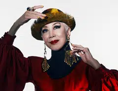 Genevieve Peggy Jeffs in red gown and black corset collar by Gucci. Headgear and jewellery are model’s own.