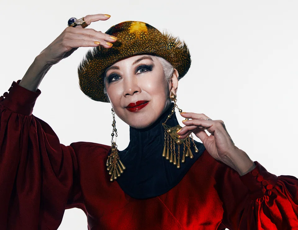 Genevieve Peggy Jeffs in red gown and black corset collar by Gucci. Headgear and jewellery are model’s own.