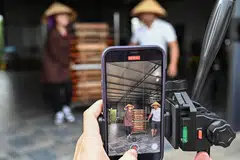 Vi Thi Anh shoots a video of noodles taken out for to drying for TikTok at her workshop in Bac Giang province. She earns vastly more hawking food products to thousands of followers as one of Vietnam's growing cadre of TikTok livestreamers. 