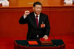Xi taking his oath during the Third Plenary Session of the National People's Congress on Friday.