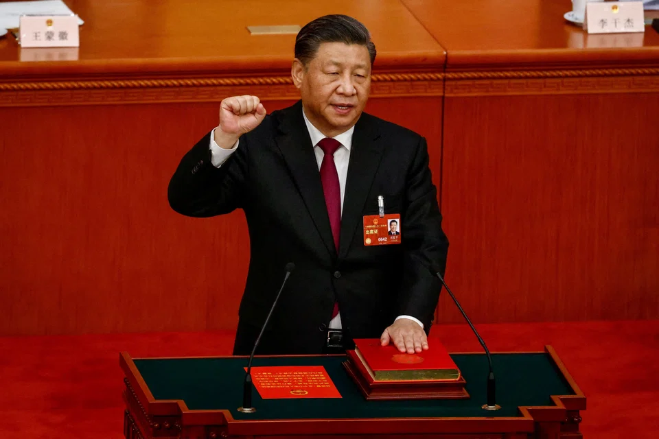 Xi taking his oath during the Third Plenary Session of the National People's Congress on Friday.