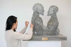 In Paperclip Embrace, two busts of humans made entirely of paperclips hold each other; the work refers to a metaphor by philosopher Nick Bostrom, who in the 2000s imagined what would happen if AI was programmed to create paper clips.