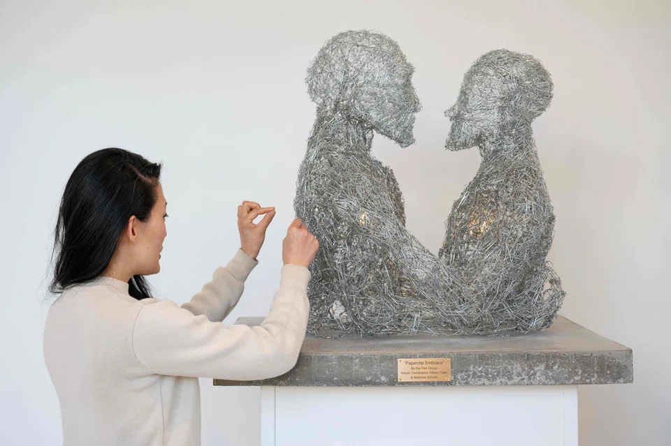In Paperclip Embrace, two busts of humans made entirely of paperclips hold each other; the work refers to a metaphor by philosopher Nick Bostrom, who in the 2000s imagined what would happen if AI was programmed to create paper clips.