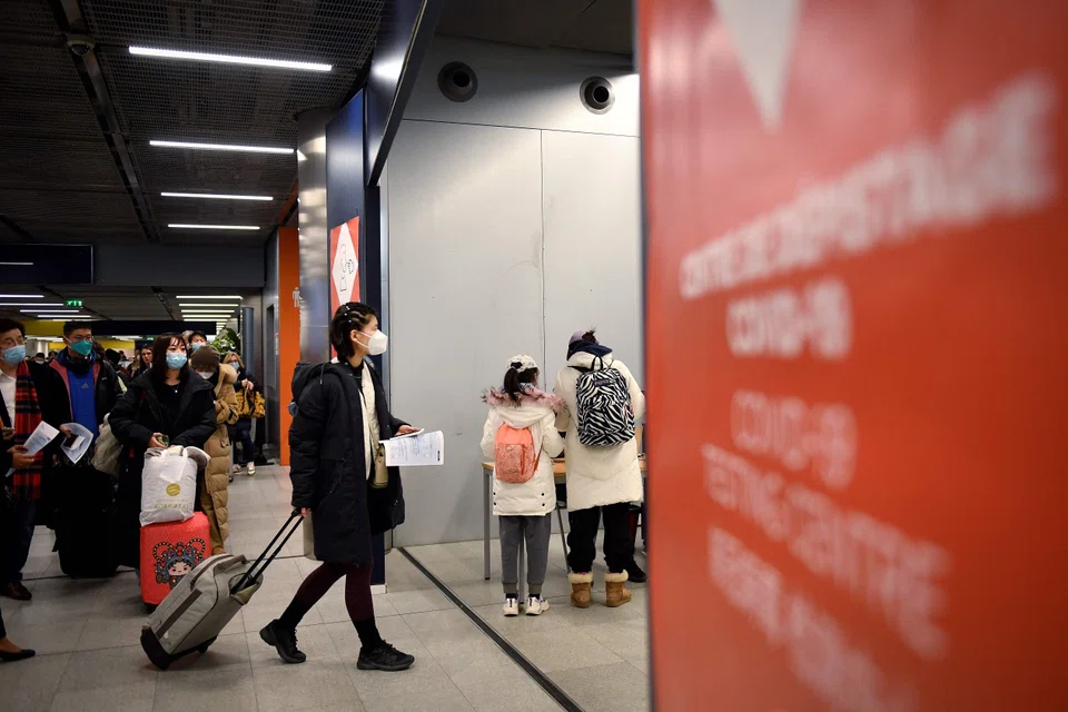 Travellers of a flight from China enter the Covid-19 testing centre of the Paris-Charles-de-Gaulle airport in Roissy, outside Paris, on Jan 1, 2023, as France reinforces health measures at the borders for passengers arriving from China.
