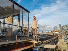 Michael Fox rents a 130-foot Dutch barge with two bedrooms, a bathroom, a galley and a lounge with a retractable glass roof. 