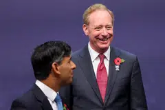 “There’s absolutely no probability that you’re going to see this so-called AGI, where computers are more powerful than people, in the next 12 months," says Microsoft's president Brad Smith(L).