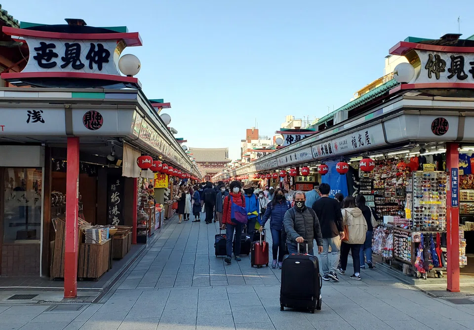 Travellers are pouring into Japan, taking advantage of a slide in the yen that has made holidays the cheapest in decades.