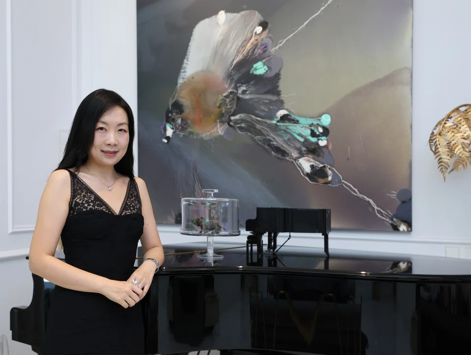 Art collector Lulu Sun, in front of a painting by Lionel Sabatte.