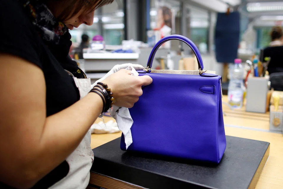 A craftswoman working on a Kelly bag at an Hermes atelier in Seloncourt, France, in 2013. 
