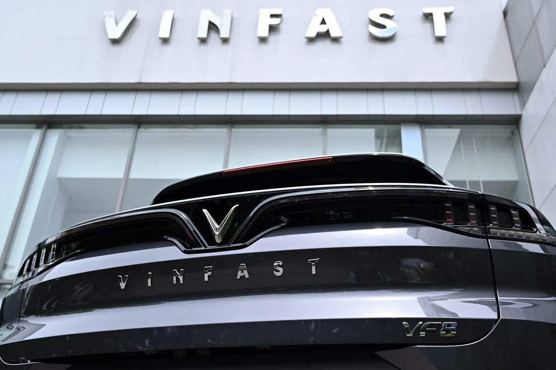 A Vinfast electric car is parked outside a showroom in Hanoi on August 18, 2023. Shares of Vietnamese electric vehicle maker VinFast have tumbled, days after its stock market valuation soared above Ford and General Motors (GM) as it debuted on the Nasdaq. (Photo by Nhac NGUYEN / AFP)