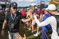 LIV Golf CEO and commissioner Greg Norman shakes hands with fans at the LIV Golf Invitational Miami tournament in October 2022.