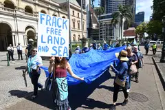 An anti-fracking protest in Brisbane, Australia, Sept 14, 2022. Origin Energy said on Monday it would sell its stake in a major fracking project that has come under criticism.