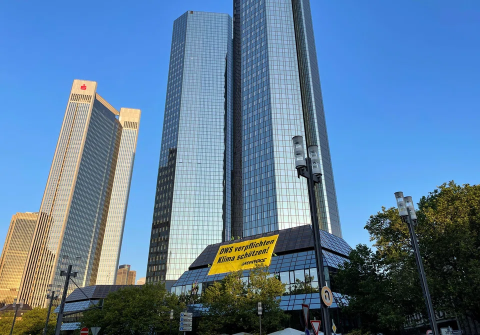 Greenpeace activists on Wednesday (Jun 14) strung up a large yellow banner on Deutsche Bank’s headquarters in Frankfurt. The German-language banner translates as “Force DWS, protect the climate”.