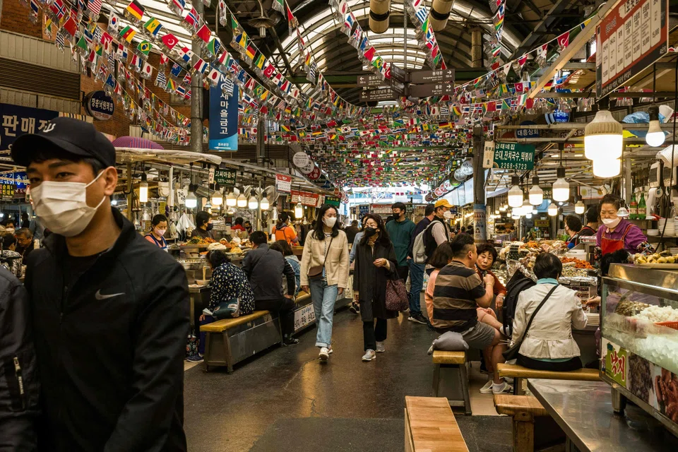 Food stalls at Gwangjang Market in Seoul; the amount approved was 2.6 trillion won more than the 59.4 trillion won announced last month and will mostly be used for cash handouts for small businesses and self-employed people to make up for losses incurred due to Covid-19 restrictions, the finance ministry says.
