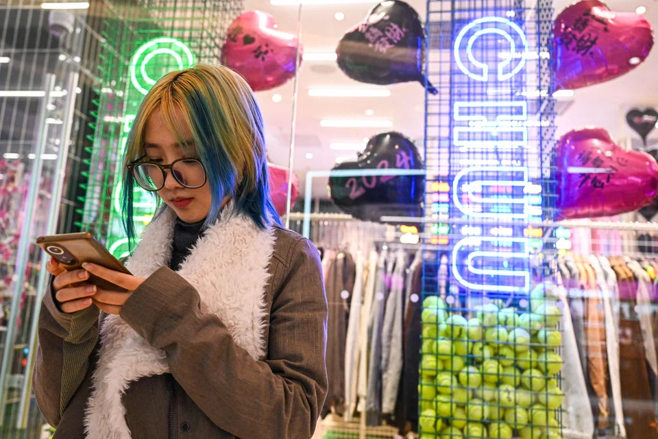Wang Xiuting chats with her virtual boyfriend on Wantalk - an artificial intelligence chatbot created by Chinese tech company Baidu, on her phone at a shopping mall in Beijing, China, Feb 2, 2024.