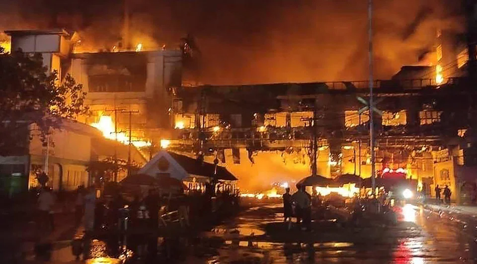 Firefighters and rescue workers at the site of a fire at the Grand Diamond City hotel-casino in Poipet, Cambodia on Dec 29, 2022. 