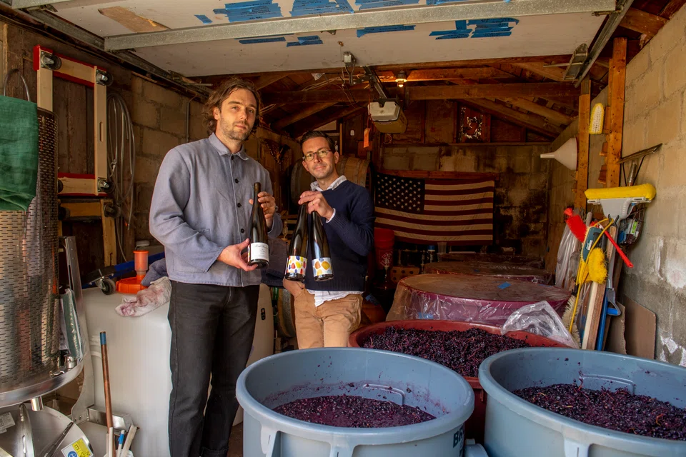 Founders of Floral Terranes Benford Lepley (left) and Erik Longabardi in his garage on Long Island, where they press apples into ciders and wines.