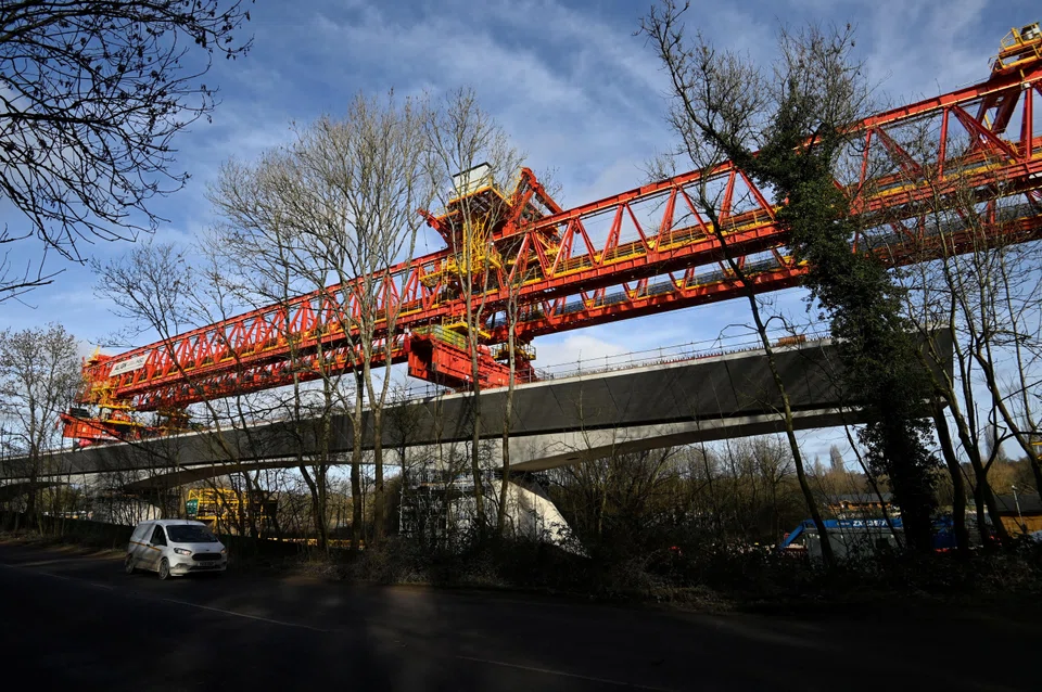 The part of the line running into central London would also be delayed, as part of cost-saving measures, Transport Minister Mark Harper said. 