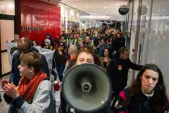 Demonstrators march through the shopping center at Chatelet les Halles, during a protest against pension reform, in Paris, France, March 18, 2023. 