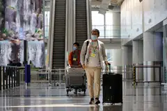 Travellers arrive at the Hong Kong International Airport on Sep 26, the first day the Covid hotel quarantine was scrapped. The easing of Covid containment measures in Hong Kong has lifted hopes that Beijing will do the same.