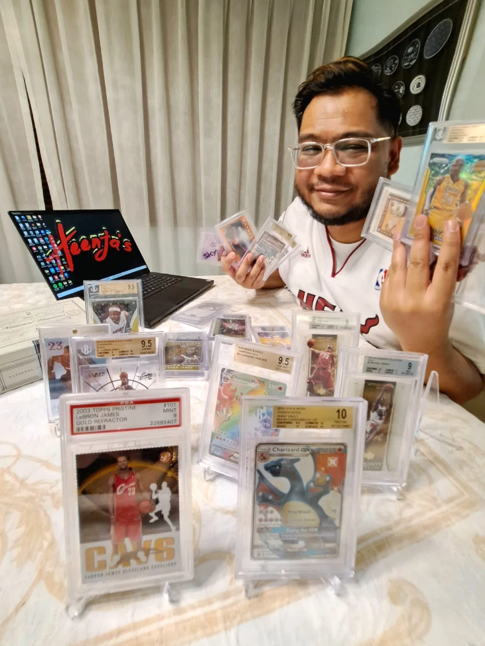 Trading card collector Fariheen Faroukh with some of his many graded cards. Having the cards graded by a professional company preserves their condition and raises their value.