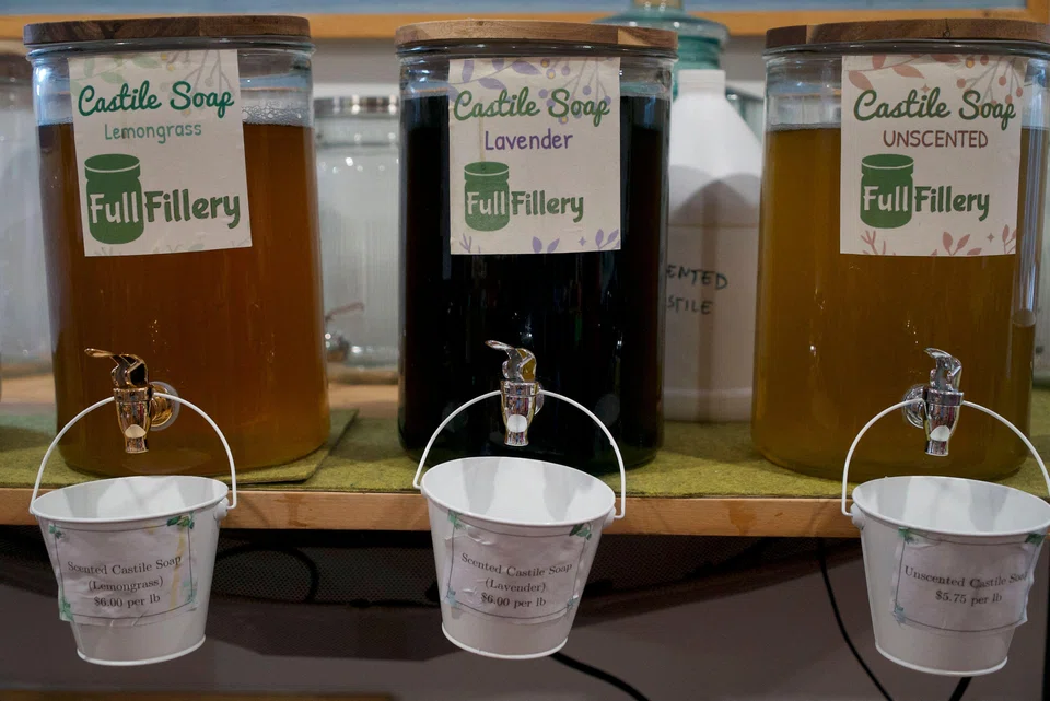 Glass jars containing liquid soap at FullFillery refill shop in Takoma Park, Maryland; over three years of existence, the business has morphed from a farmer’s market stall to a large store lined with environmentally friendly products and extremely limited packaging.