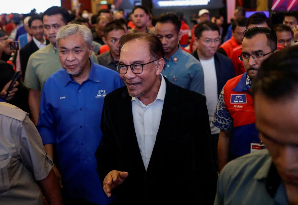 Malaysian PM Anwar Ibrahim, with Umno president Ahmad Zahid Hamidi on his right, leaving a press conference in Kuala Lumpur after the release of the state election results on Saturday;  it will require all of his ingenuity and ability to coalesce opposing forces to hold the unity government together.