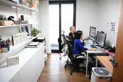 Erin Lim, CEO of Konny, working with her husband Kim Dong-hyun during an interview with AFP at her home in Seoul. 