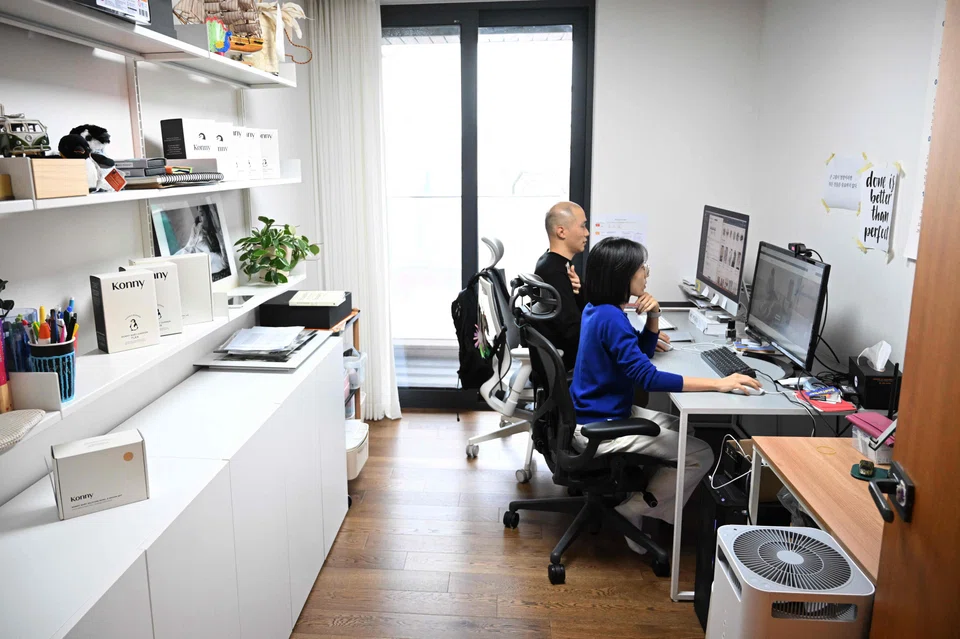 Erin Lim, CEO of Konny, working with her husband Kim Dong-hyun during an interview with AFP at her home in Seoul. 