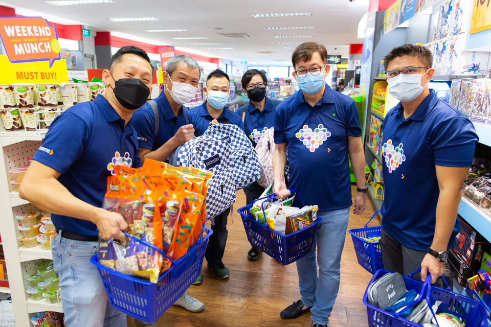 Certis president and group CEO Paul Chong (second from right) together with other senior leaders at an event to pack school bags for children and youths from low-income families in Singapore.