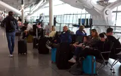 Passengers rest on benches at Heathrow airport in London;   Airports across Europe have struggled to cope with a post-pandemic rebound in demand, but British airports have been particularly hit by major disruption over the past week.