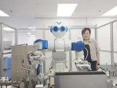 Eunice Ng with Ms Ugene, the company's first robot, which was introduced in 2014. 