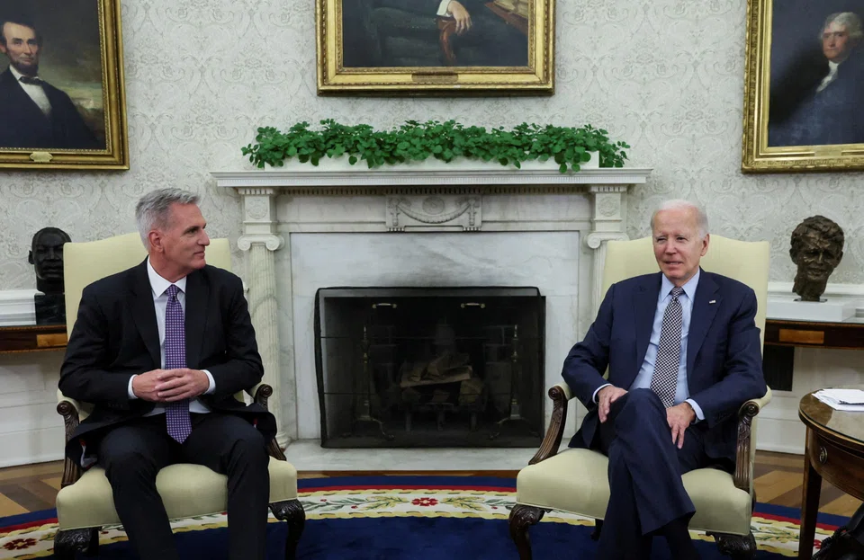 US President Joe Biden, right, and US House Speaker Kevin McCarthy have reached a deal to raise the country's debt ceiling, averting a potential default by the world's largest economy.