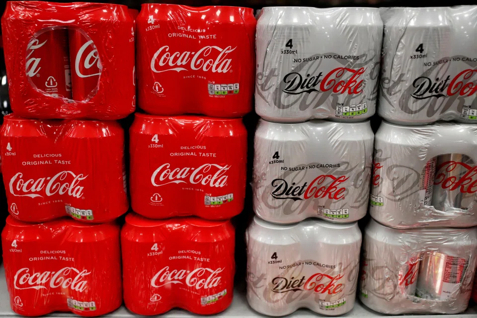 FILE PHOTO: Multi can packs of Coca Cola and Diet Coke are seen for sale in a motorway services shop, Reading, Britain, January 25, 2019. REUTERS/Peter Cziborra/File Photo