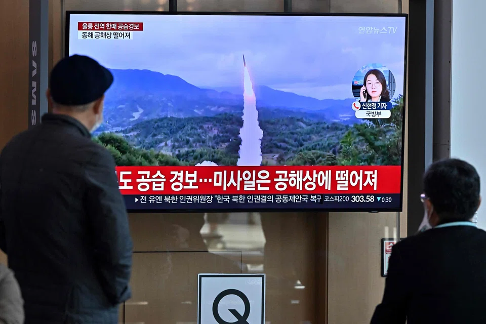 People watch a television screen showing a news broadcast about a North Korean missile test in Seoul, Nov 2, 2022. In October, North Korea test-fired a ballistic missile farther than ever before, sending it soaring over Japan for the first time in five years.