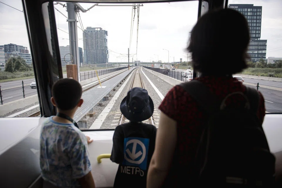 Visitors riding the Reseau Express Metropolitain (REM) light rail during its inauguration ceremony; the project ran into unforeseen obstacles, including the Covid pandemic and the discovery of 100-year-old explosives in a tunnel, which pushed the budget from C$5 billion to more than C$7 billion.
