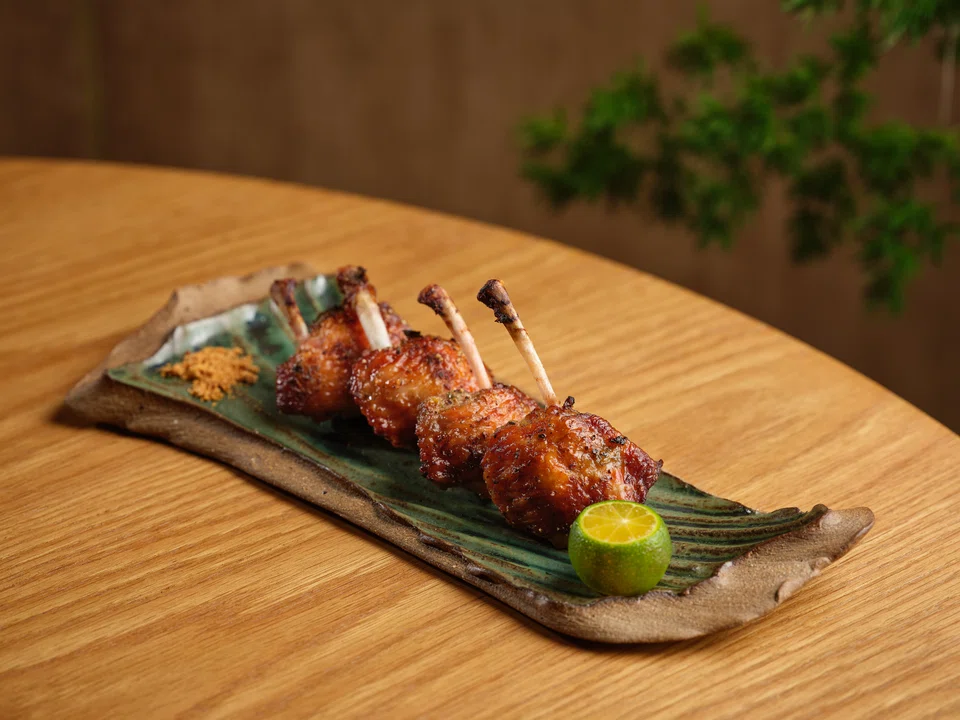 Umami chicken wings are well-seasoned and char-broiled.