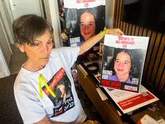  Kamelia Hoter Ishay, 73, grandmother of Gali Tarshansky, 13, who was taken hostage on Oct 7 during the deadly attack by Palestinian Islamist group Hamas, holds up a poster with a picture of Gali.