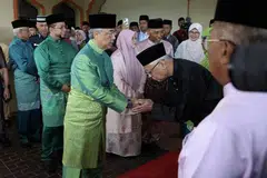 Malaysia's King Sultan Abdullah Ahmad Shah (in green) being greeted by Prime Minister Ismail Sabri Yaakob (in black) at an event to mark Maulidur Rasul, in Kuala Lumpur, on Oct 9, 2022. 