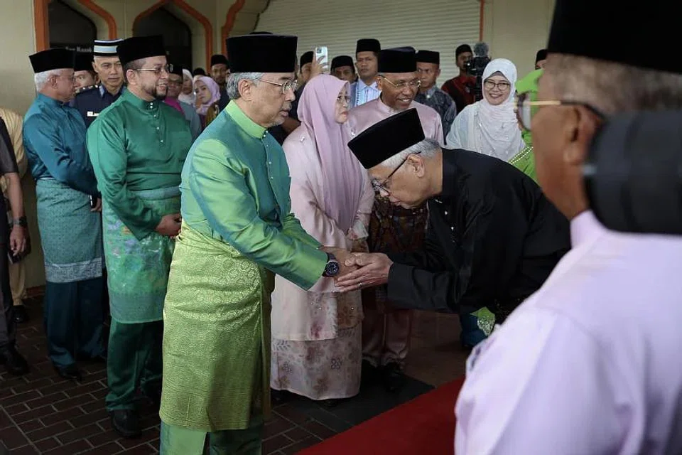 Malaysia's King Sultan Abdullah Ahmad Shah (in green) being greeted by Prime Minister Ismail Sabri Yaakob (in black) at an event to mark Maulidur Rasul, in Kuala Lumpur, on Oct 9, 2022. 
