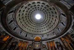 The Pantheon, dating to the 2nd century AD, is a circular concrete building faced with brick, boasting the world’s largest and oldest unreinforced concrete dome. 