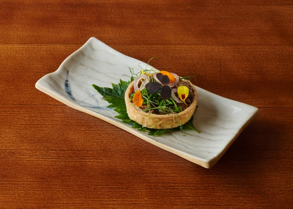 Crisp tart filled with a wagyu-onion mixture on camembert cheese.