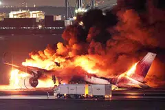 A Japan Airlines airliner burst into flames on Tuesday as it skidded down the tarmac following a collision with a Japanese Coast Guard aircraft that killed five of six crew on the smaller craft.