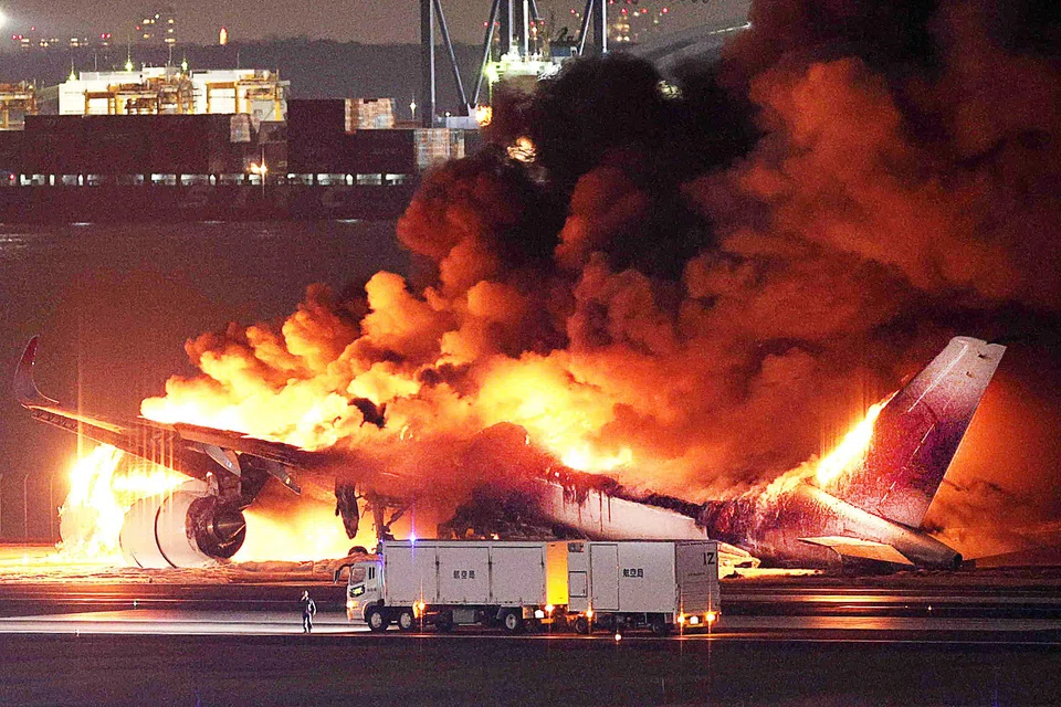 A Japan Airlines airliner burst into flames on Tuesday as it skidded down the tarmac following a collision with a Japanese Coast Guard aircraft that killed five of six crew on the smaller craft.