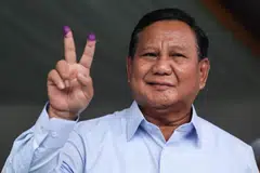 Indonesia's Prabowo Subianto gestures after casting his ballot to vote in Indonesia’s presidential and legislative elections in Bogor, Indonesia, Feb 14, 2024.