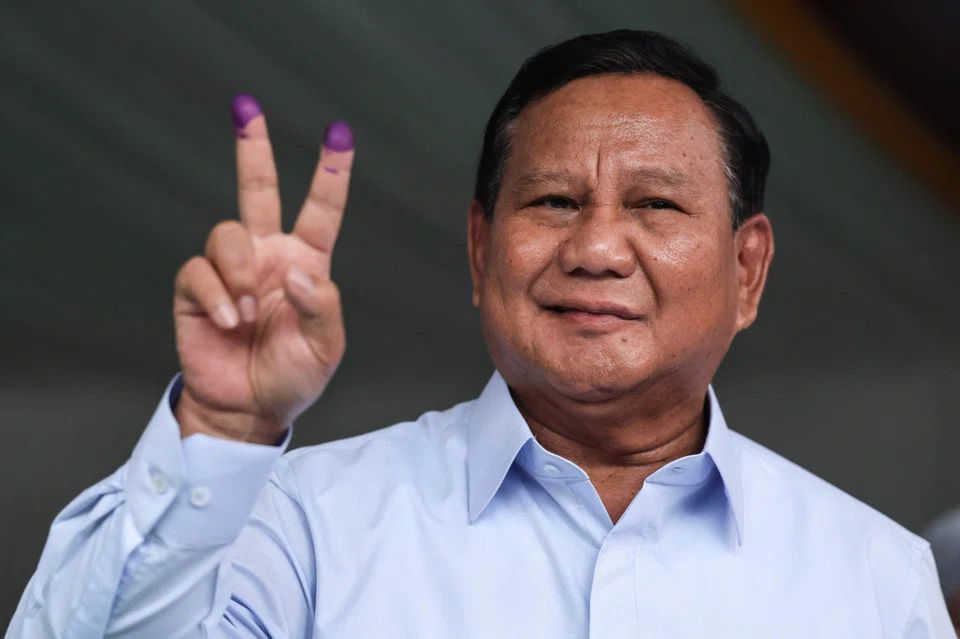Indonesia's Prabowo Subianto gestures after casting his ballot to vote in Indonesia’s presidential and legislative elections in Bogor, Indonesia, Feb 14, 2024.