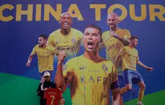 A Ronaldo fan posing for a picture prior to a training session in Shenzhen. Al Nassr Football Club has apologised for the cancellation of two matches due to the football superstar's injury.
